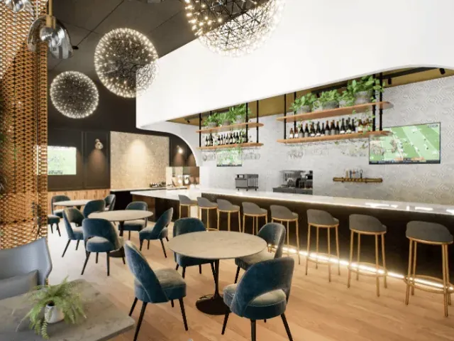 Cafe counter with pendant lights and blue upholstered seating