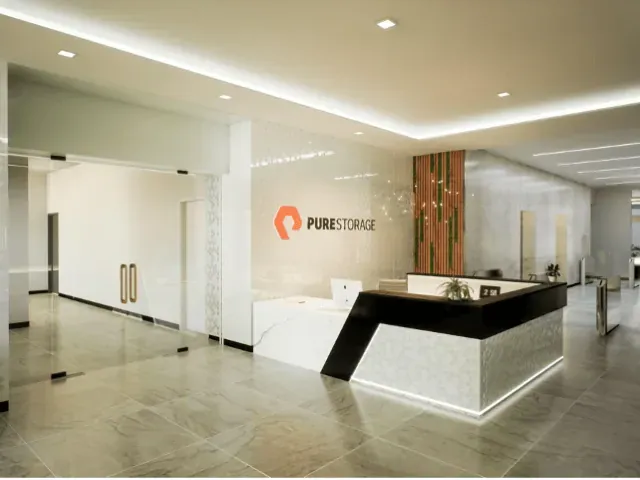 Corporate reception desk in a light stone lobby